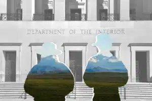 photo illustration / composition of a silhouette of 2 rangers in front of the Department of the Interior building